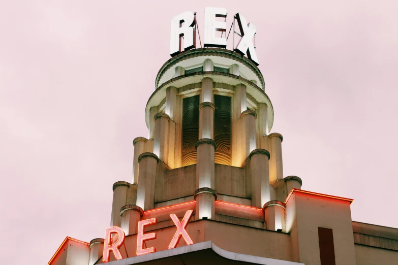 an architectural building with a red fox lit up and a neon sign underneath it