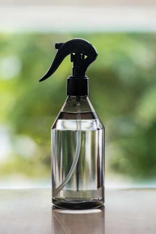 a plastic bottle with a black handle sitting on a table