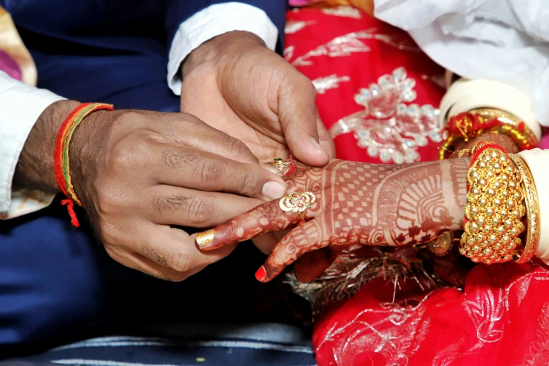 a couple getting married on the hands of each other