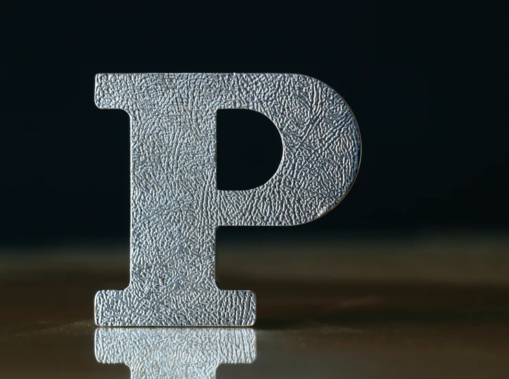 the letter p of paper is placed on a table