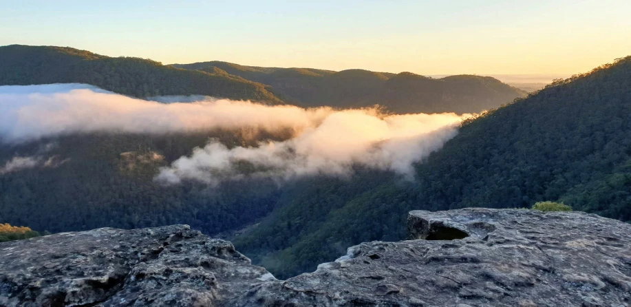 view of a valley that has low hanging clouds