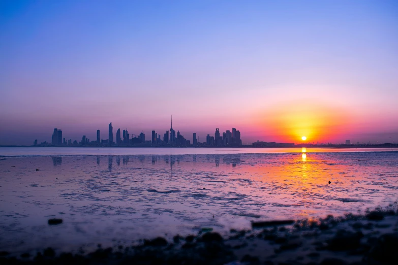 the sun is setting over a large body of water