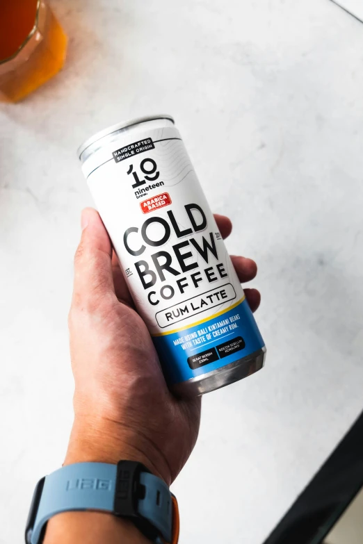 a hand holding a can of cold brew coffee