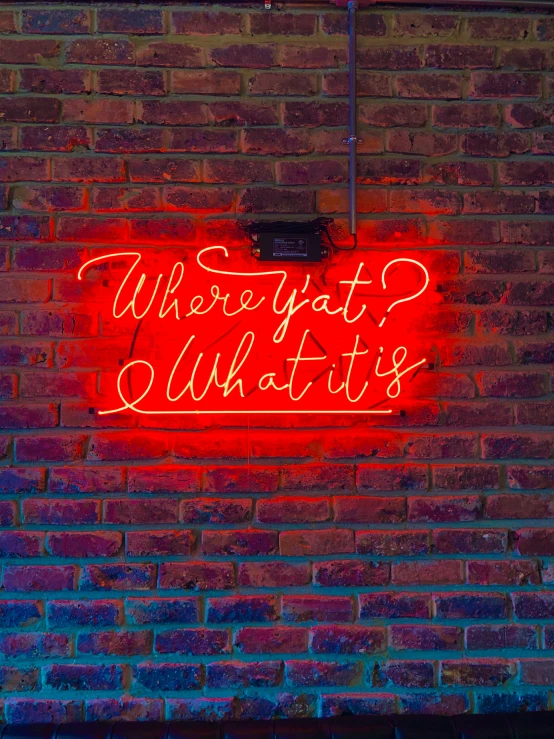 a brick wall has a neon sign that says, where did you put it?