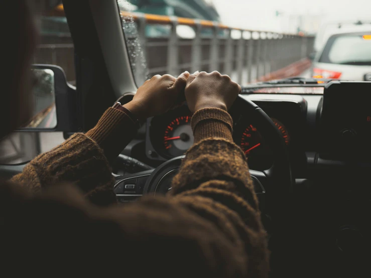 a man drives in his car on the street