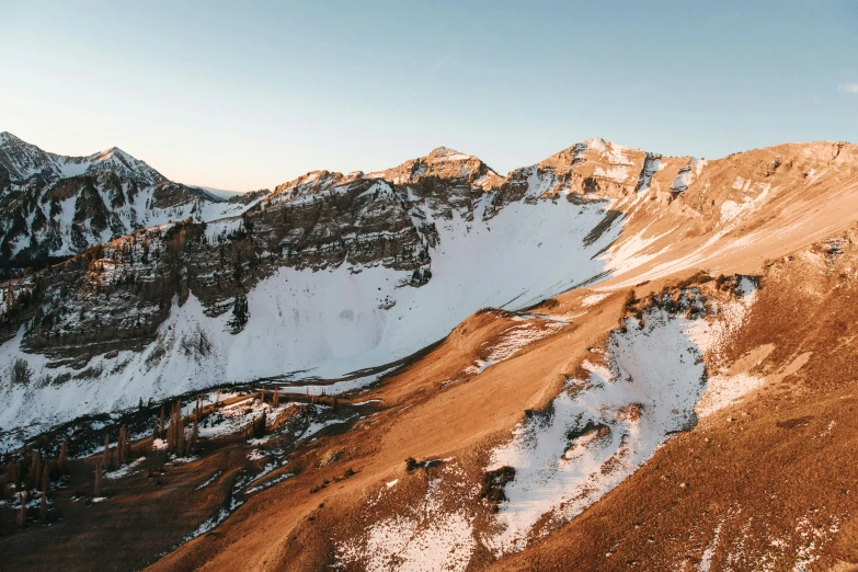 snow - covered mountains are seen from the air