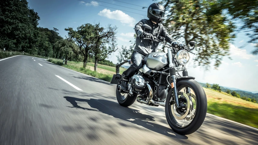 a person on a motorcycle in the middle of the road