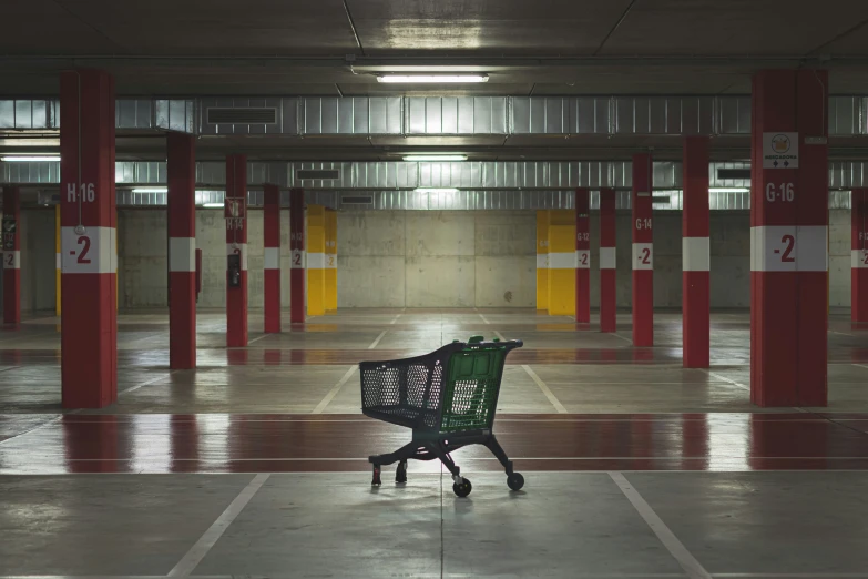 a empty shopping cart sitting in a large garage