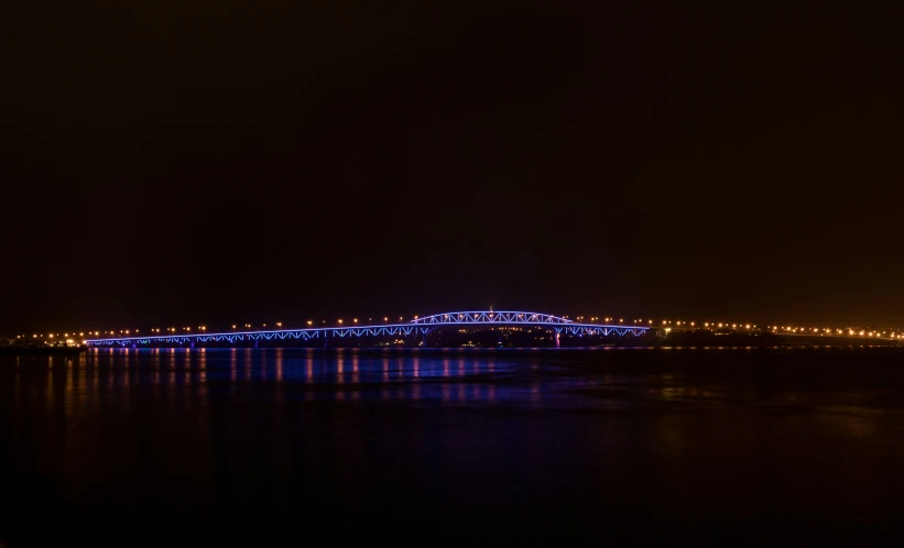 a colorful bridge spanning the width of a river