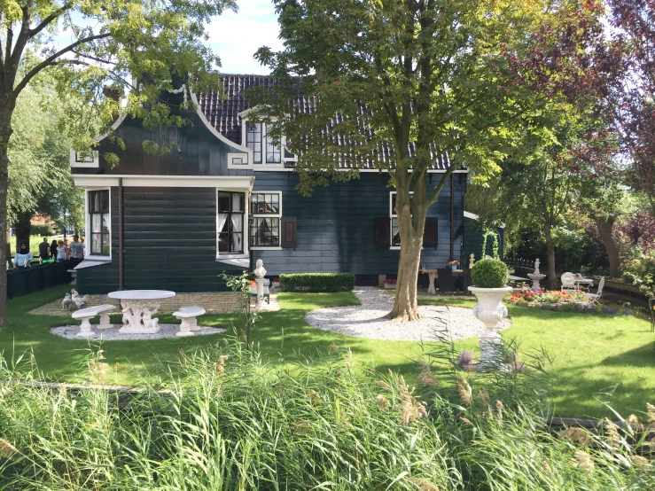 a picture of a small wooden house that is on a grassy lot