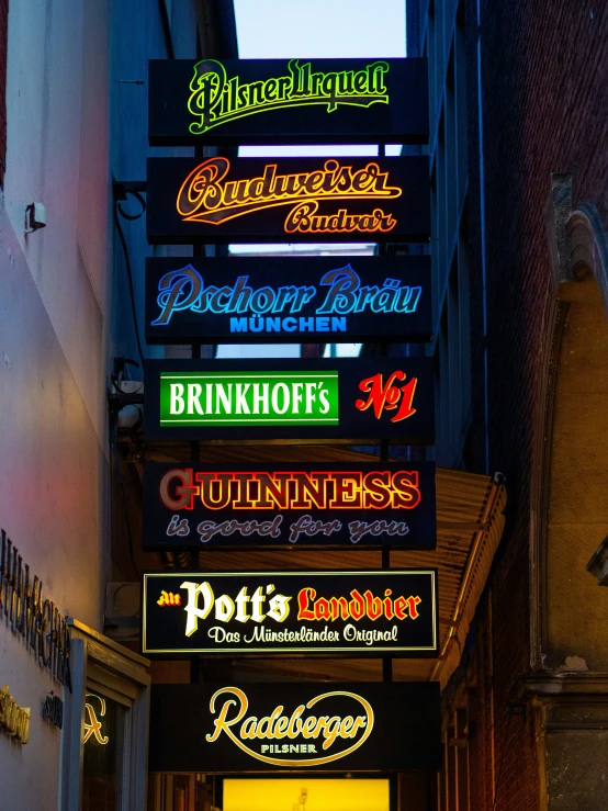 the colorful signs hang from the side of a building