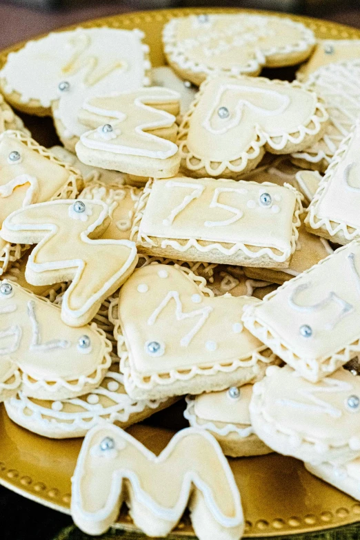 a gold plate topped with cut out cookies