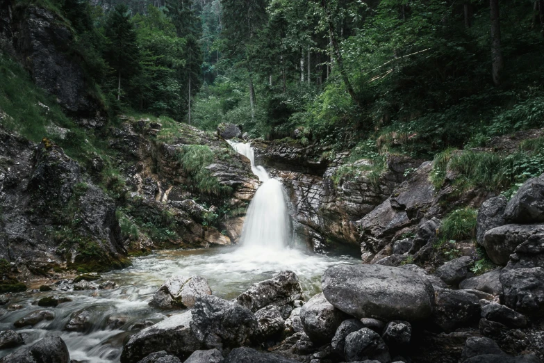 a large waterfall falls into some water