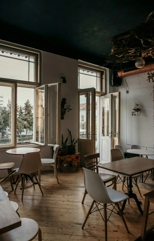 an open dining room with lots of windows and furniture