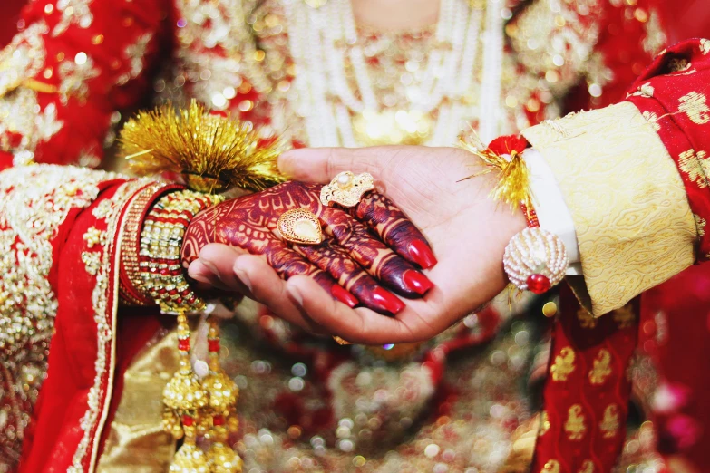 hands full of colorfully decorated hens are held by the bride