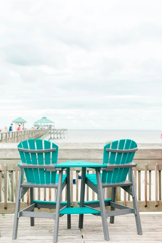 two chairs on a deck facing the ocean