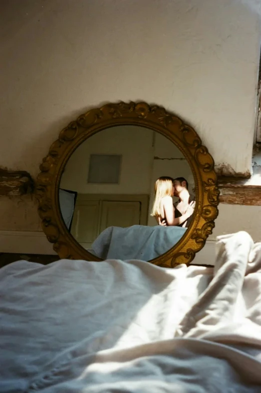 two women emcing each other and looking in the mirror