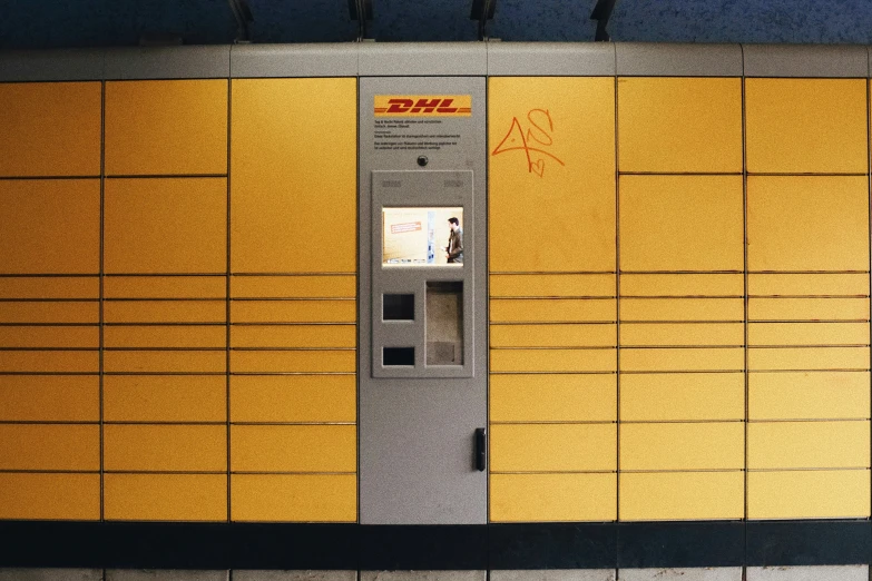 a silver metal locker sitting on a tiled wall