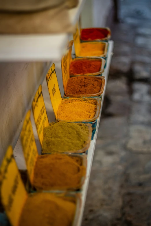 an array of spices that are in rows on a counter