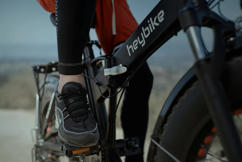 a woman riding her bike with no shoes on