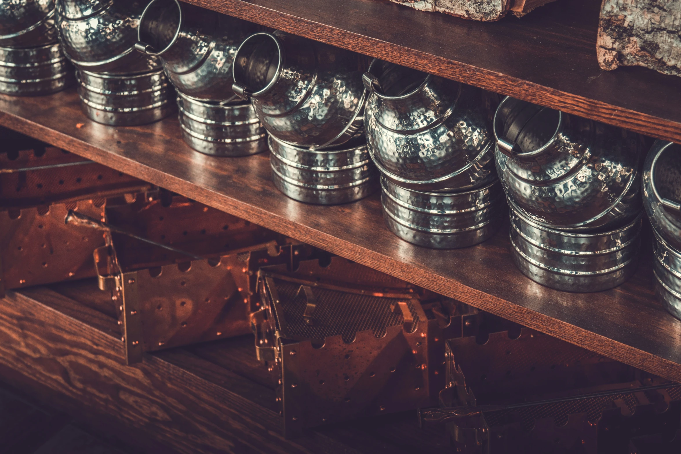 many different metal items and boxes on a shelf