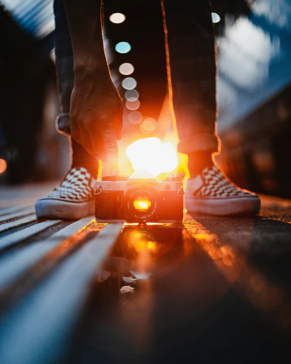 a person standing next to a street with their feet on a street light