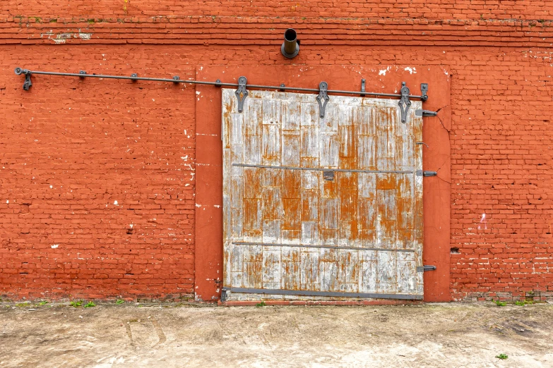 an old door is on an orange brick building