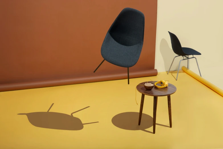 two chairs on yellow floor next to a brown wall