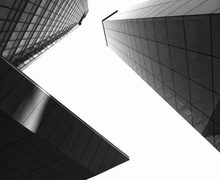 a pair of large buildings with the sky in the background