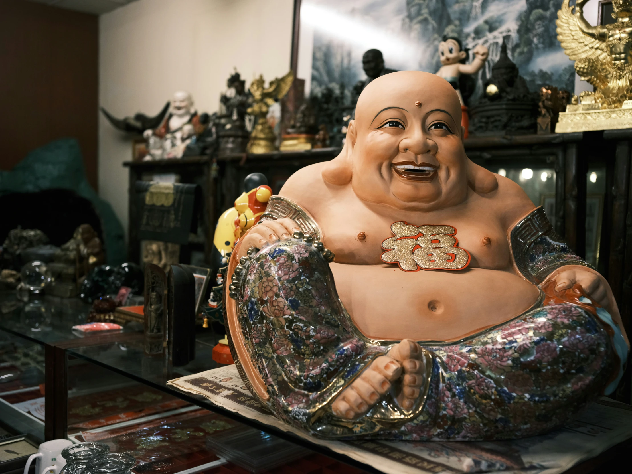 an oriental statue sits on display in front of other statues