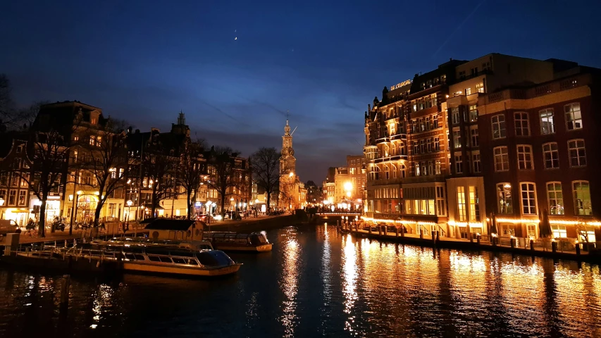 some boats are docked at night on the water