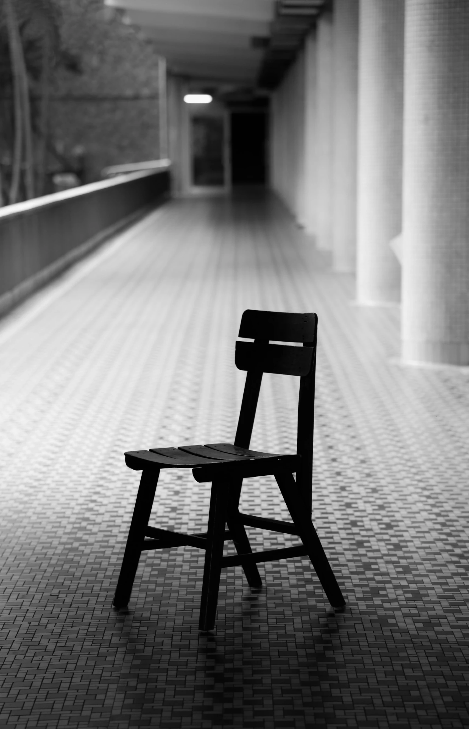 the wooden bench sits alone beside the building