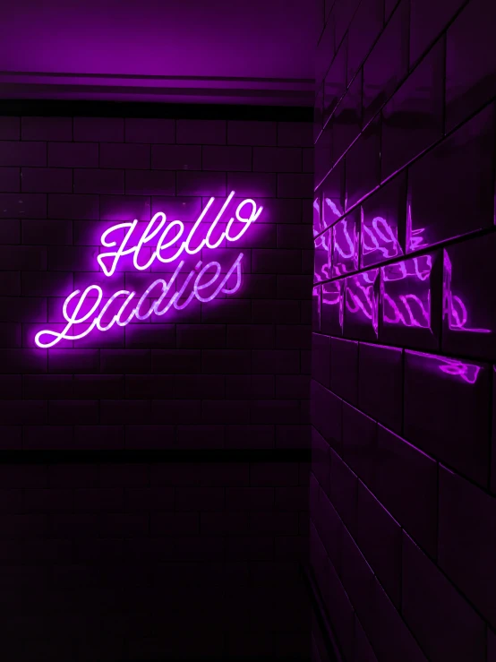 a neon sign is shown in a hallway