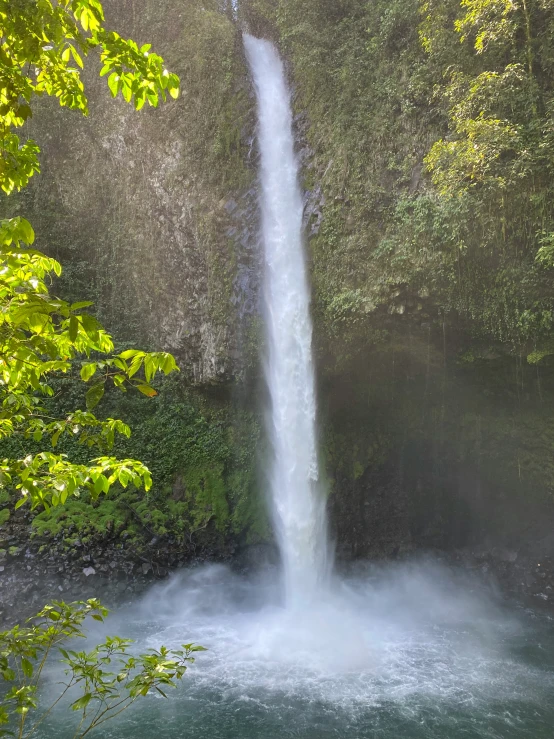 a waterfall running into the air through trees