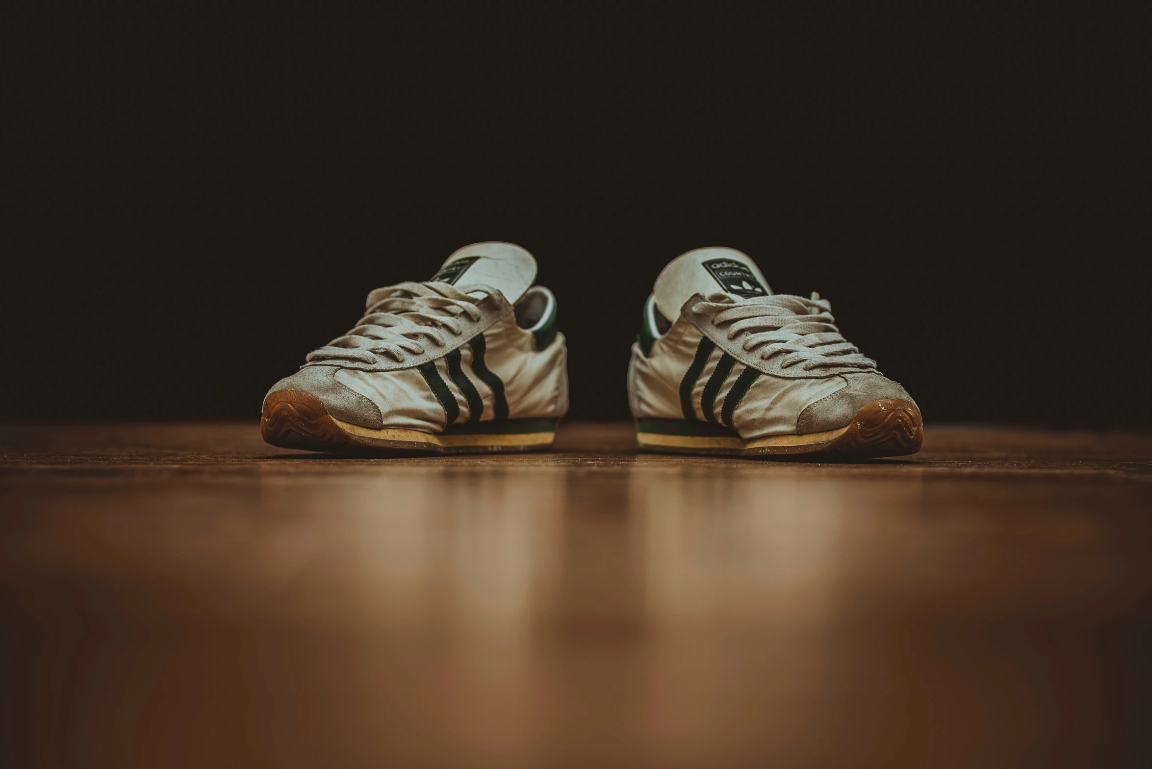 pair of white and black sneakers on floor