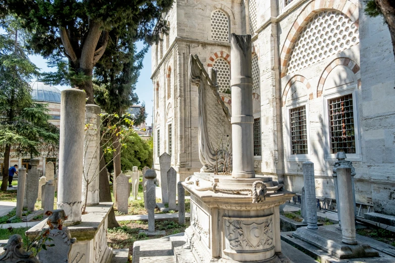 the outdoor gothic cemetery has statues around it