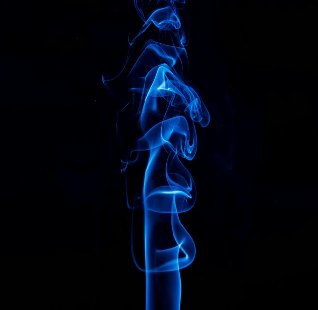 the smoke is being captured on a dark background