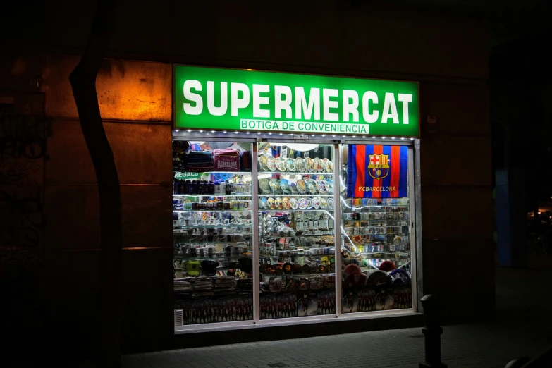 a lighted store front on a street corner
