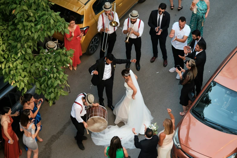 a woman in a dress standing next to a wedding party