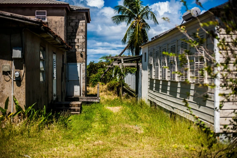 a wooden pathway leading between two shacks