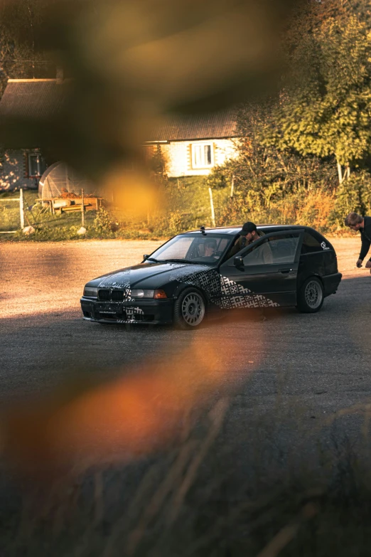 a black car is parked in a lot