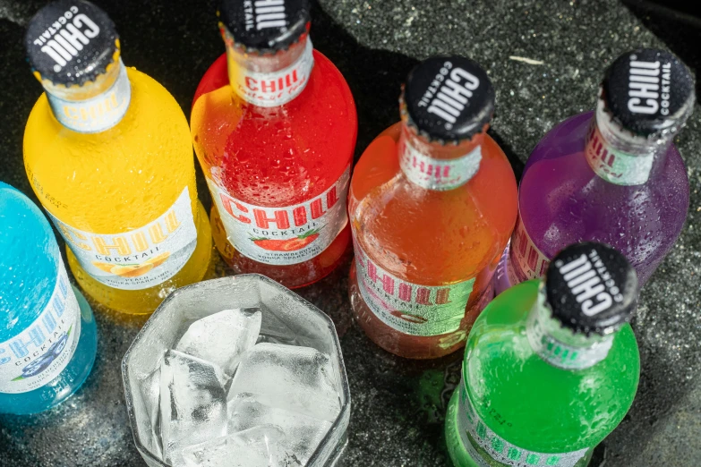 there are seven colorful soda bottles with different colors