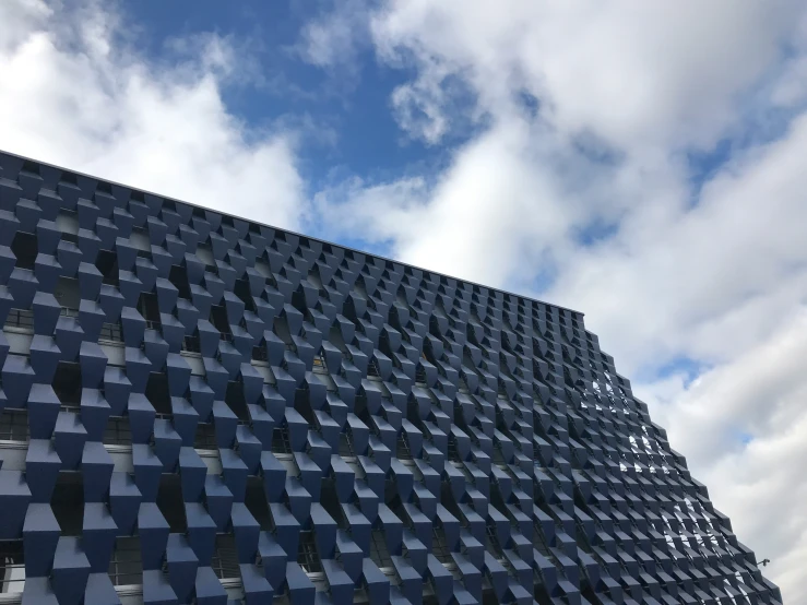 a building with large triangular shapes and blue sky