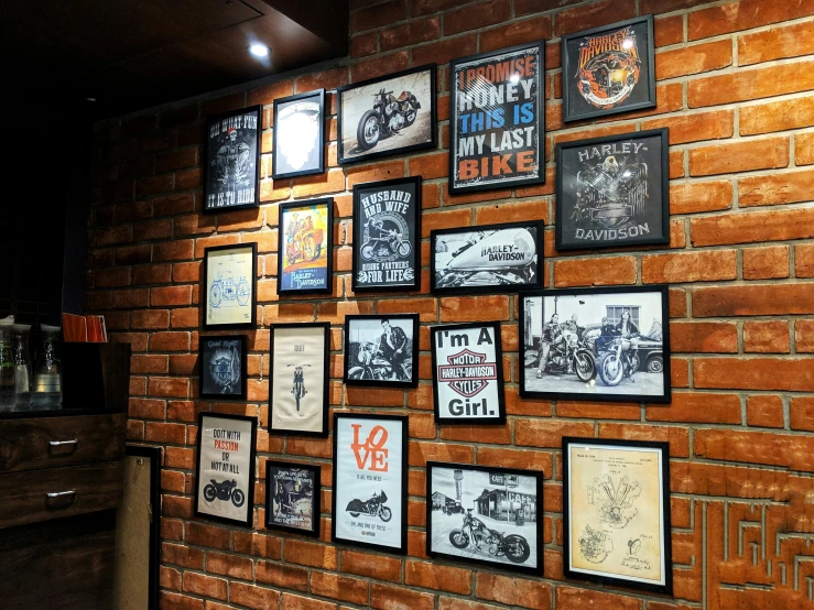 an old brick wall has a wall displaying posters