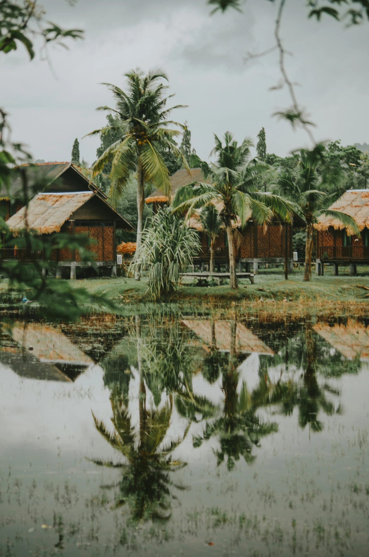 an old hut reflecting in a body of water