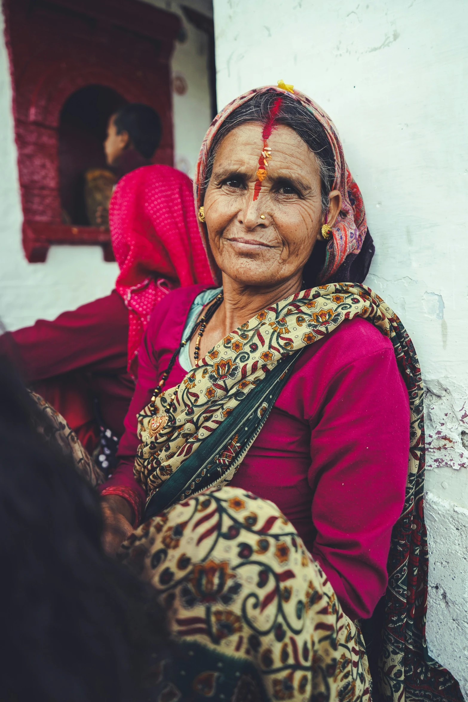 an old lady in red poses for a po