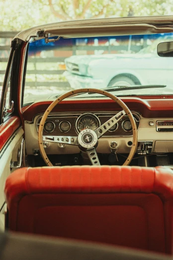 the interior of an older car that is red