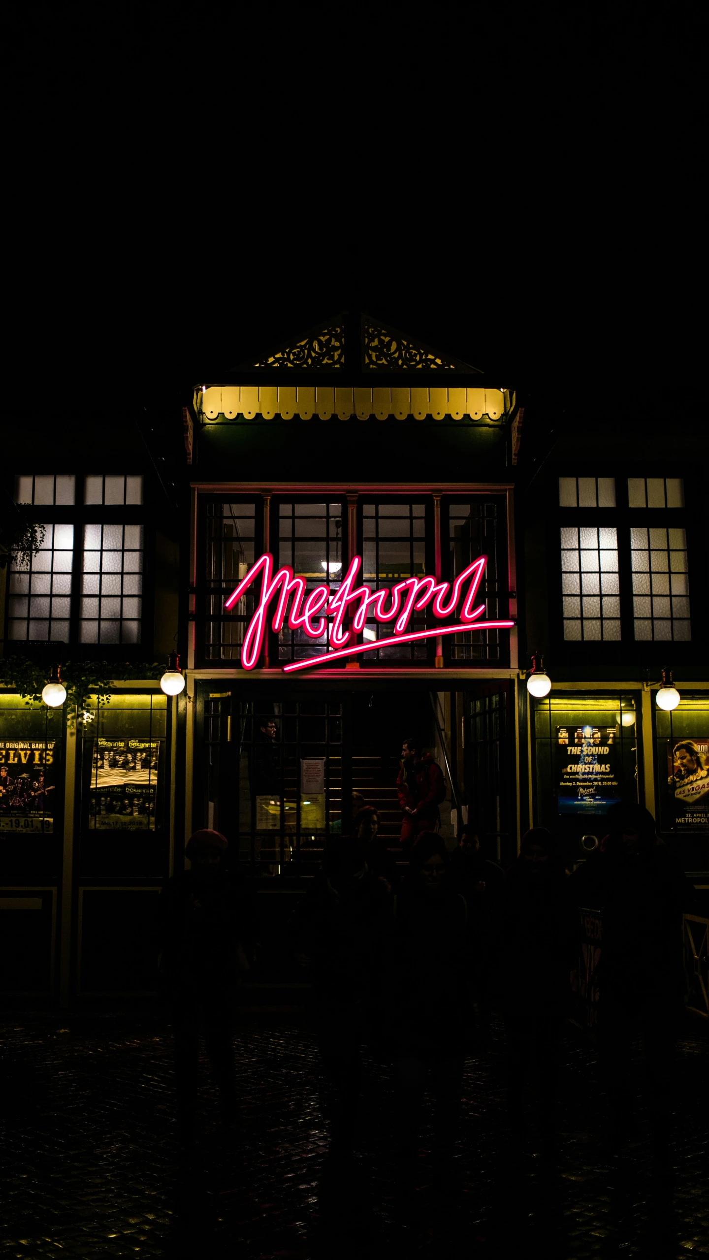 a large building with a neon sign in the middle