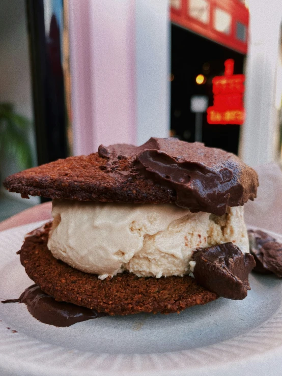 two chocolate and white ice cream sandwiches are on a plate