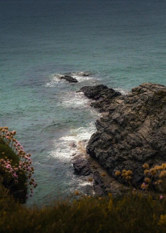 a rocky coastline with a bunch of water in the background